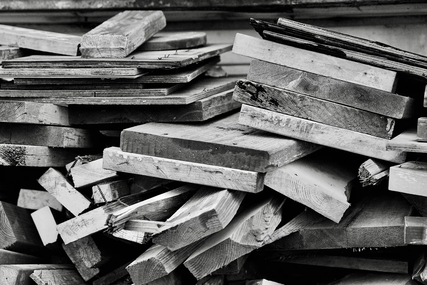 Illustrative photograph of stacked rough wooden planks